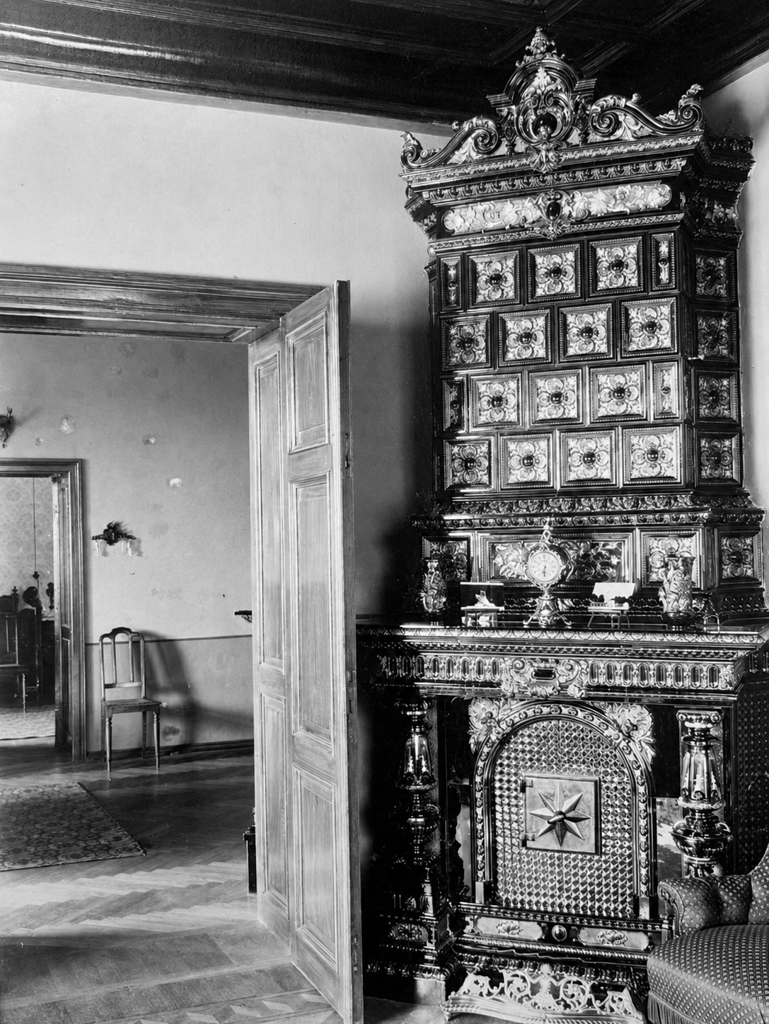 Master-crafted glazed ceramic stove and fireplace in representative salon