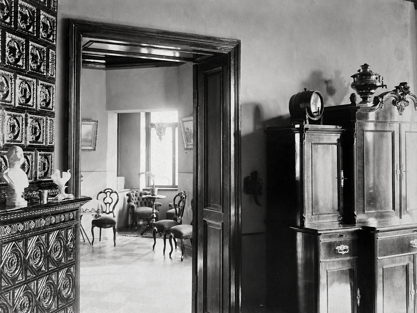 Enfilade perspective into the private drawing room with period armchairs and high windows