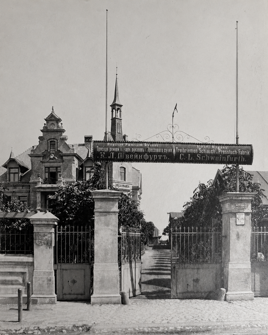 Historic entrance gate with Schweinfurth signage framing Villa Maria